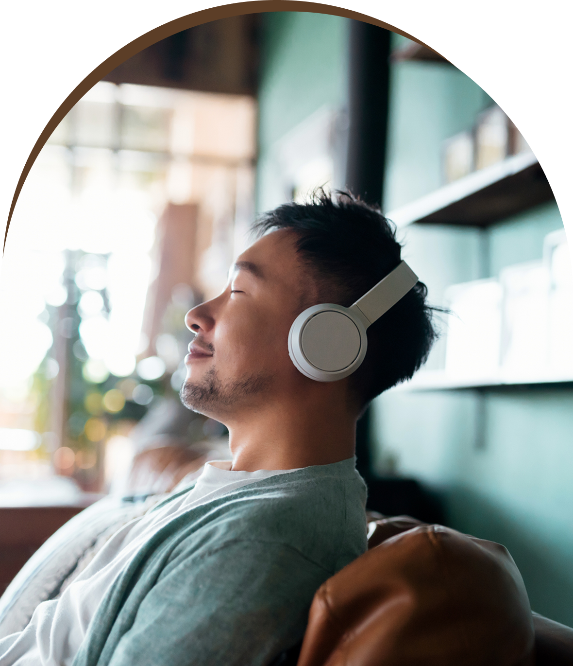 Group 1321317386 A man with headphones on listening to music.