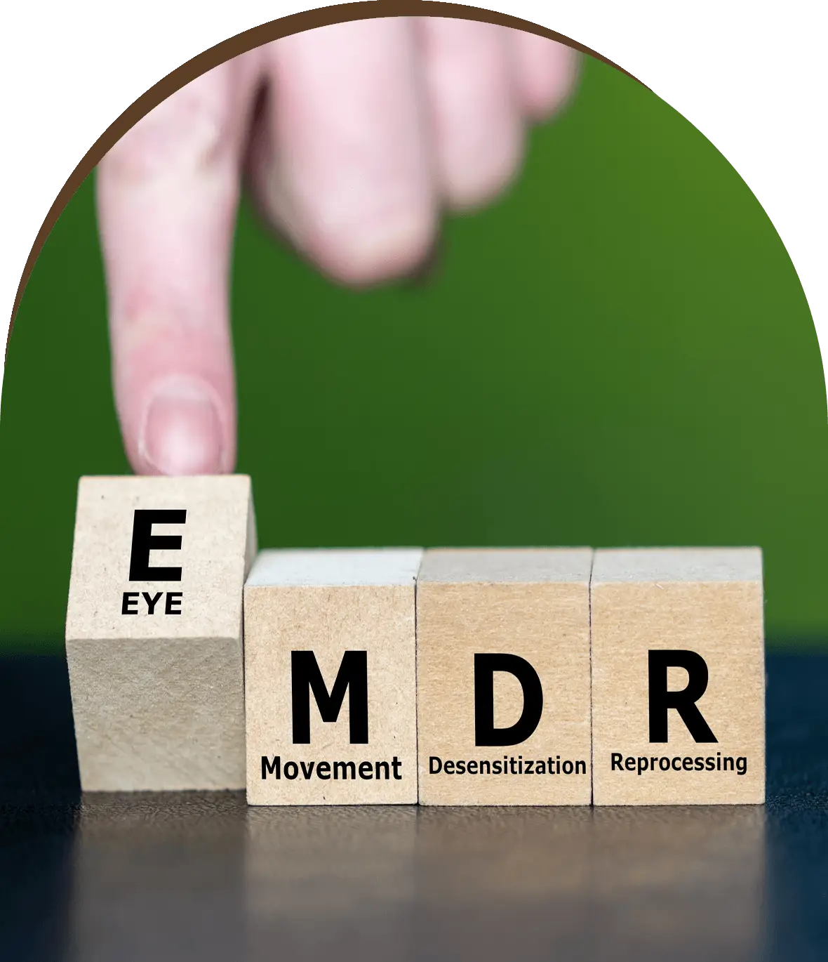 Group-1321317395.png A hand is holding out blocks that spell out the word " emdr ".