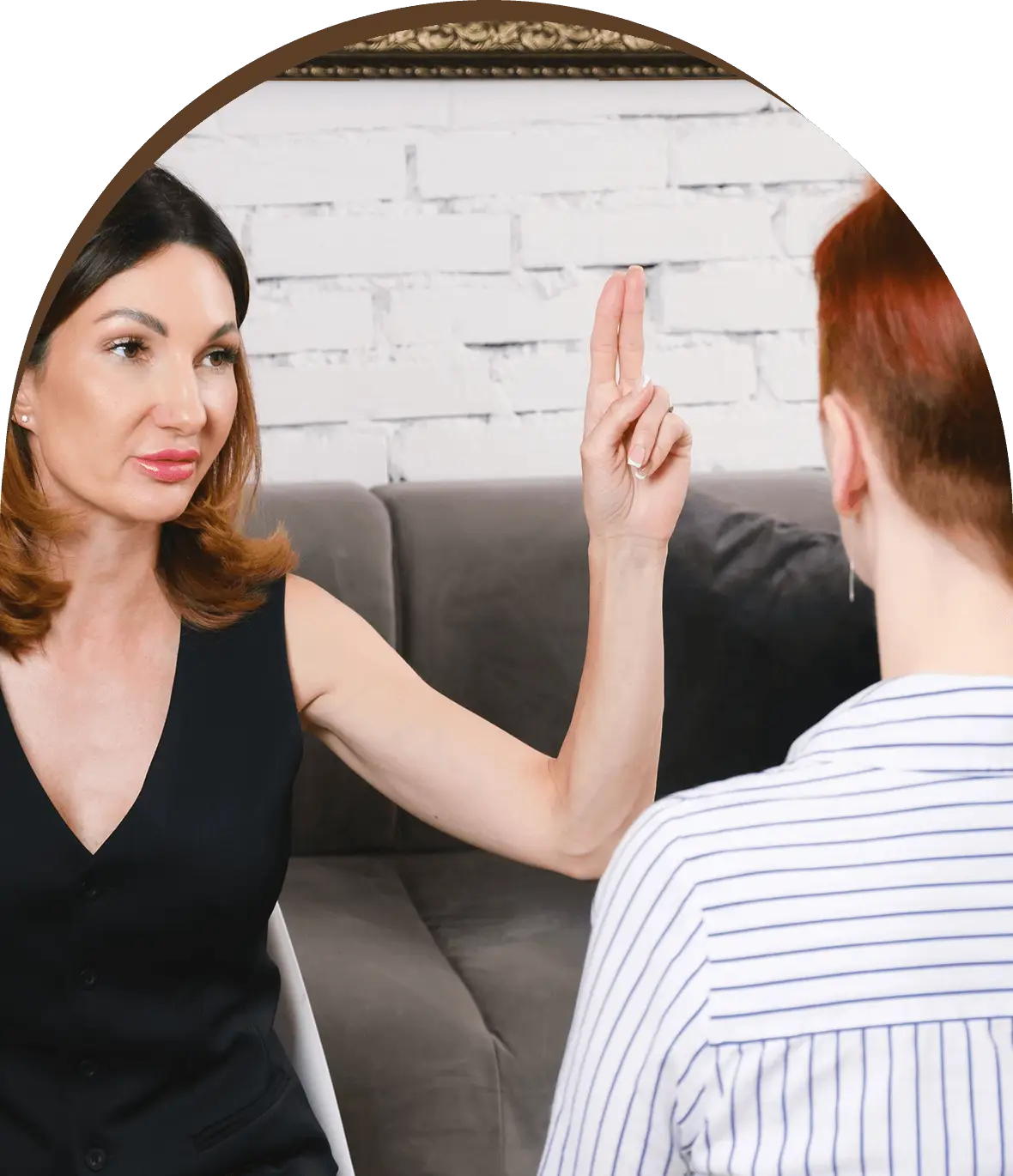 Group-1321317399.png A woman is sitting on the couch and pointing at her man.