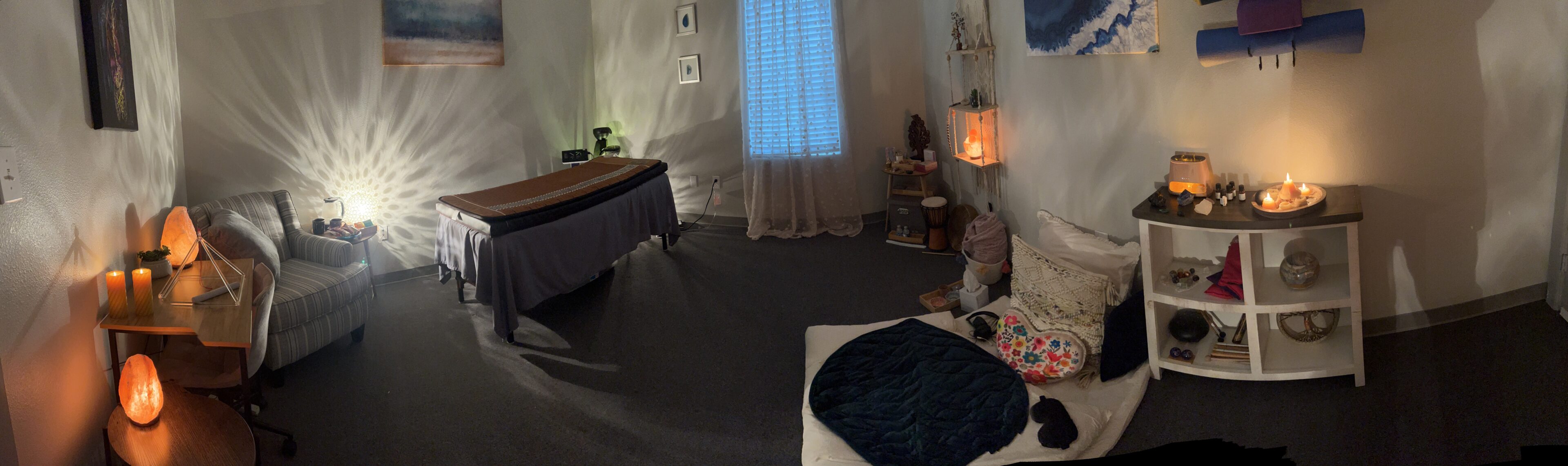 Somatic Wellness Center-7515a82 A room with a bed, table and curtains.